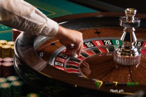 a casino dealer is putting the ball in the roulette wheel